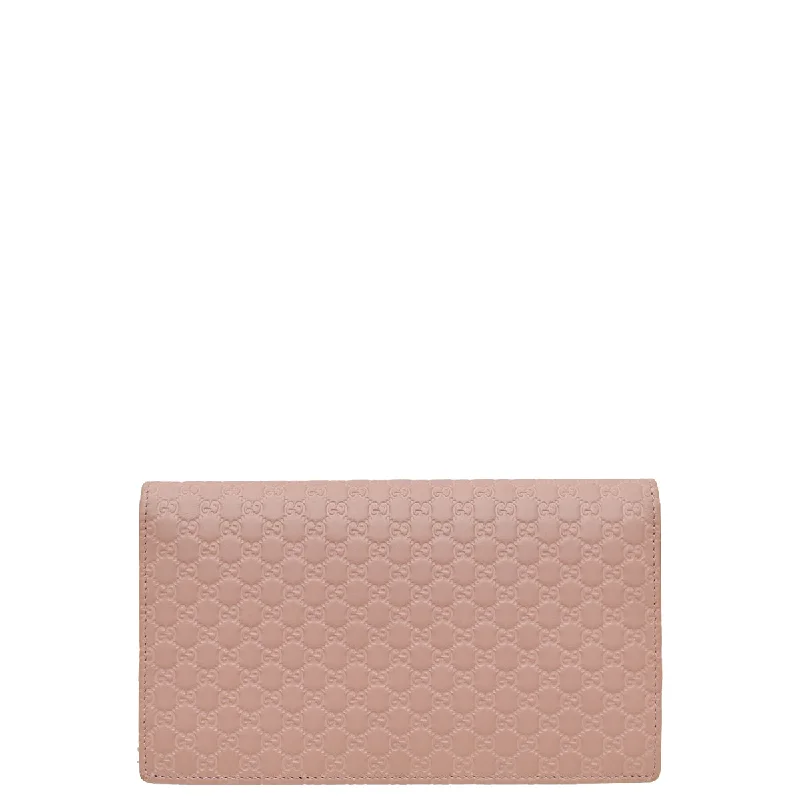 Women Gucci Sylvie bags with a crystal - embellished web stripeGucci Dust Pink GG Microguccissima Strap Wallet